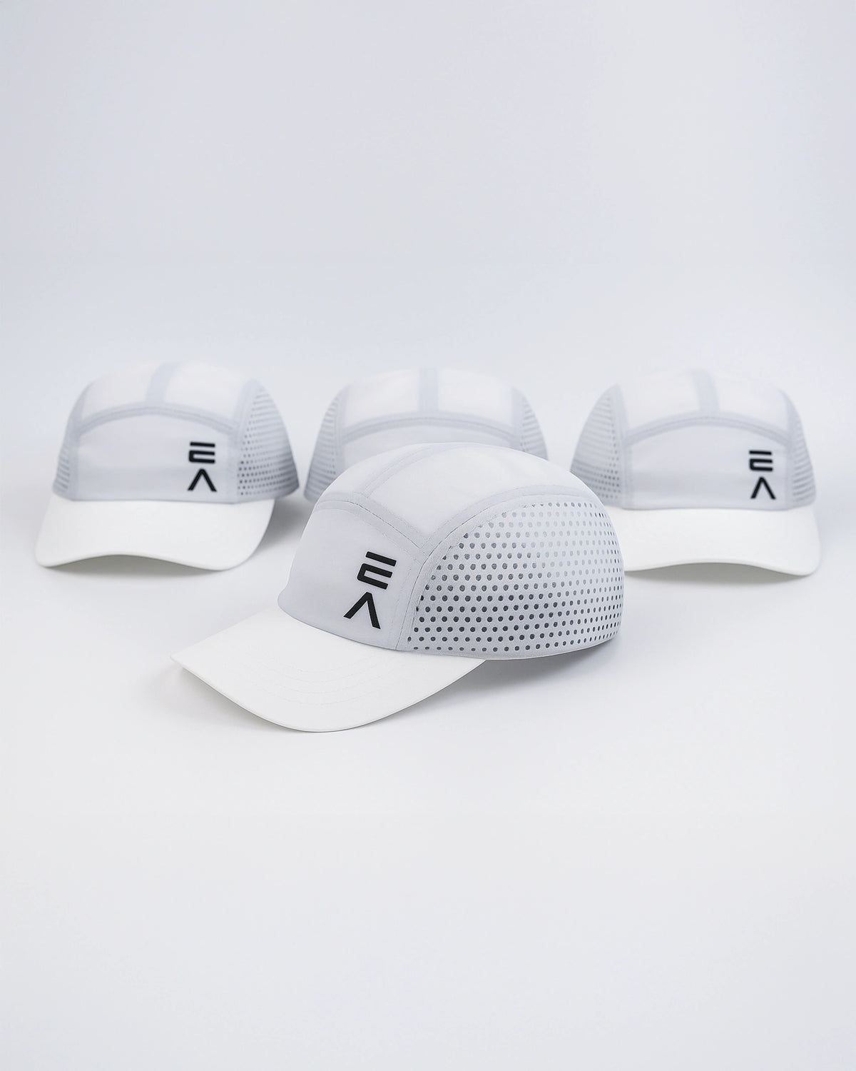 Four Evo Ice white EVOActive Unisex Core Run Caps arranged front-facing, with one cap in front at a slight side angle