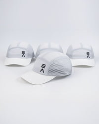Four Evo Ice white EVOActive Unisex Core Run Caps arranged front-facing, with one cap in front at a slight side angle