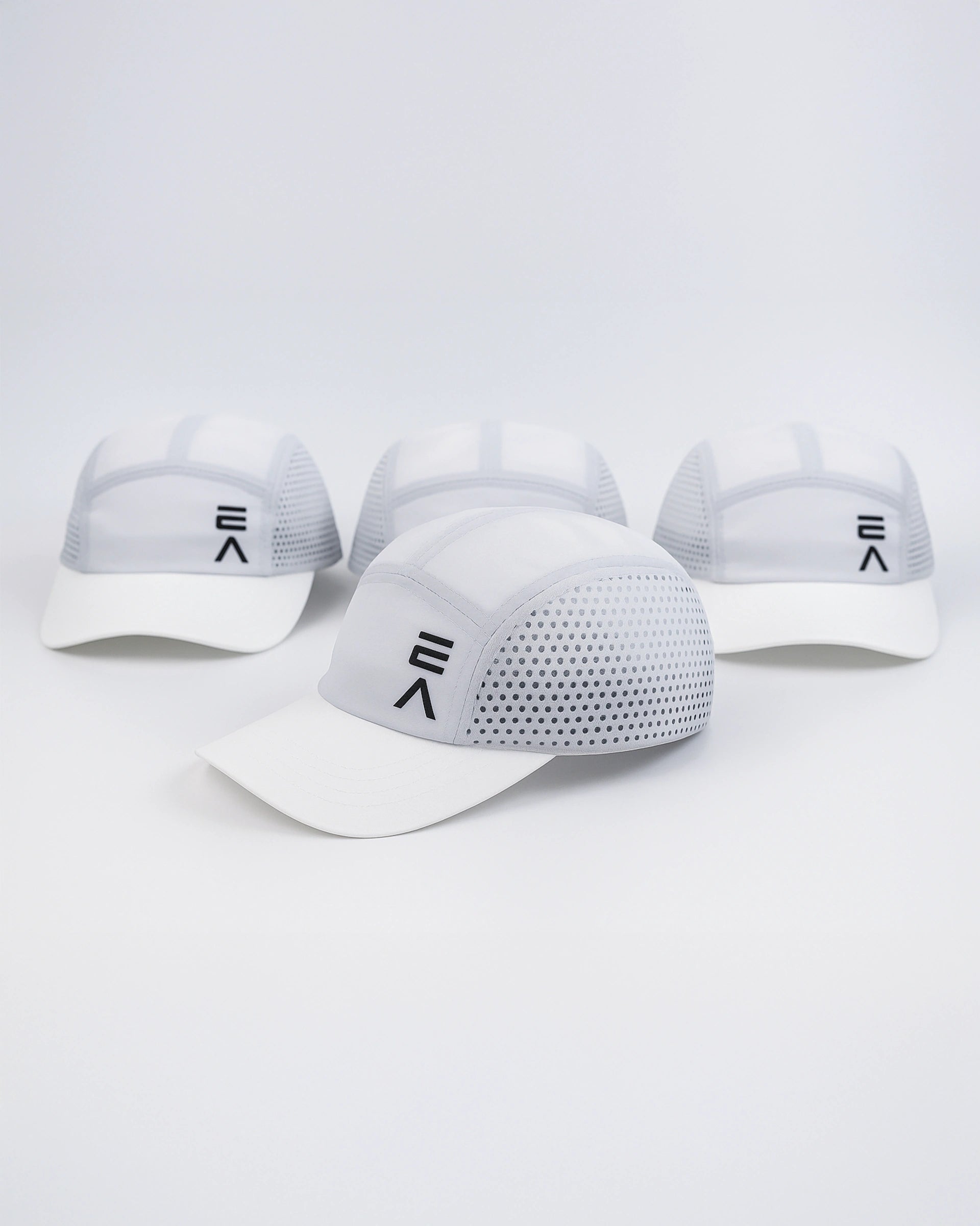 Four Evo Ice white EVOActive Unisex Core Run Caps arranged front-facing, with one cap in front at a slight side angle