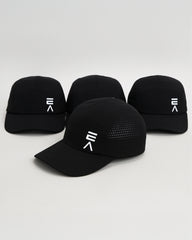 Studio product image of four midnight black EVOActive Unisex Core Run Caps, all showing the front, with one cap in front at a slight side angle and logos visible against a bright background
