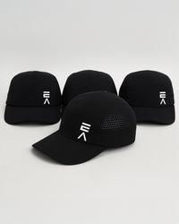 Studio product image of four midnight black EVOActive Unisex Core Run Caps, all showing the front, with one cap in front at a slight side angle and logos visible against a bright background