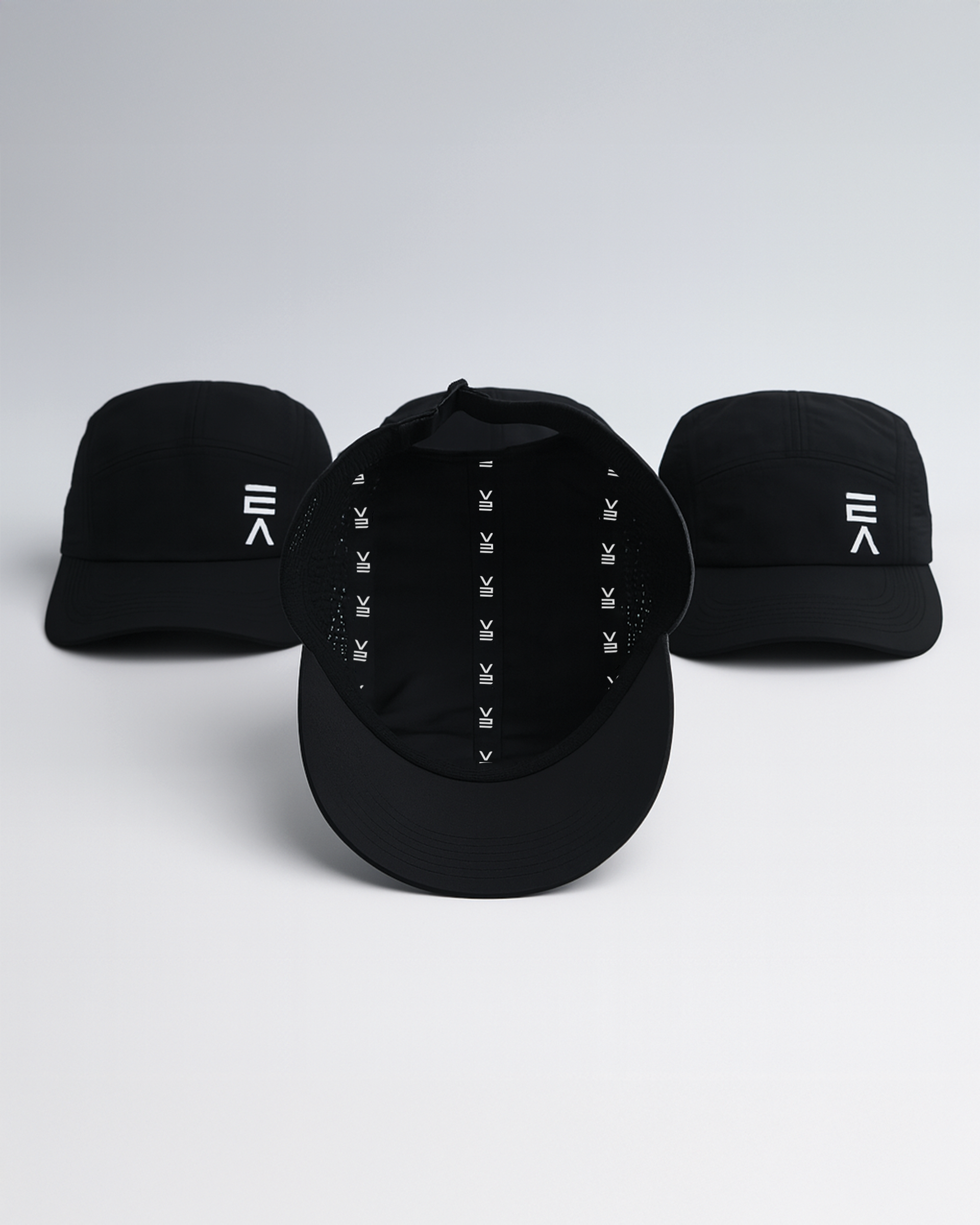 Studio product image of three midnight black EVOActive Unisex Core Run Caps, with one cap shown from the inside displaying the EVOActive logo