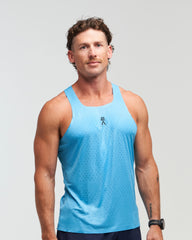 Front view of man wearing ocean blue EVOActive Men’s Aero Singlet with logo visible against a bright background