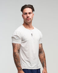 Front view of man wearing Evo Ice white EVOActive Men’s Aero Tee with logo visible against a bright background