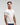 Front view of man wearing Evo Ice white EVOActive Men’s Aero Tee with logo visible against a bright background