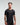Front view of man wearing midnight black EVOActive Men’s Aero Tee with logo visible against a bright background