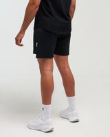Lower half back view of man wearing midnight black EVOActive Men’s FlexMotion Shorts with logo visible