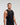 Front view of man wearing midnight black EVOActive Men’s Flex Singlet in a slight side pose with logo visible