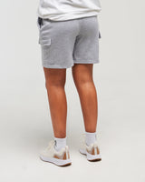Lower-body back view of woman wearing Clouded Grey Unisex Classic Jogger Short against a white background
