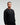 Front view of man wearing midnight black EVOActive Unisex Classic LS Crew Neck Tee with logo visible on the garment against a bright background