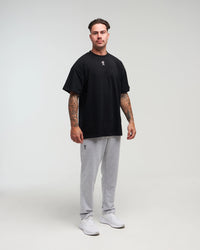 Full body view of man wearing clouded grey Unisex Classic Straight-Leg Jogger Pant against a bright background