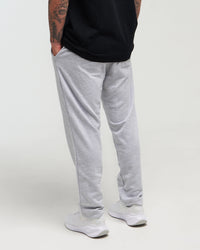 Lower-body back view of man wearing clouded grey Unisex Classic Straight-Leg Jogger Pant against a bright background
