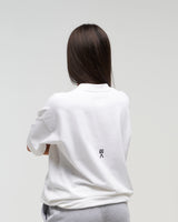 Back view of woman wearing Evo Ice white EVOActive Unisex Classic Tee with logo visible against a bright plain background