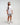 Full body view of woman wearing Evo Ice white EVOActive Unisex Classic Tee with logo visible against a bright plain background