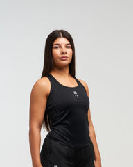Woman wearing black EVOActive Women’s CoreRacer Singlet sleeveless sports top with logo against bright background
