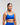 Front view of woman wearing storm blue EVOActive Women’s Elevate Open Back Sports Bra in a slight side pose with logo visible