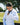 Woman wearing Evo Ice white EVOActive Women’s Horizon Jacket zipping it up while standing against green tree background with logo visible