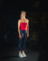 Full body front view of woman wearing midnight black Women’s Motion Pocket Leggings in a slight side pose