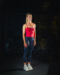 Full body front view of woman wearing midnight black Women’s Motion Pocket Leggings in a slight side pose